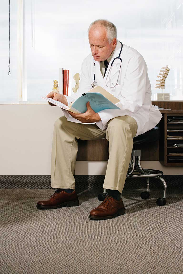 Doctor reading medical chart